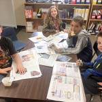 Jessie Chartier, Trinity Morefield, Jacob Carleson and Colby Verdu  students in teacher Brooke Hoeflers fourth-grade class at Helen Haller Elementary School  enjoy reading the community section of the Sequim Gazette. Submitted photo