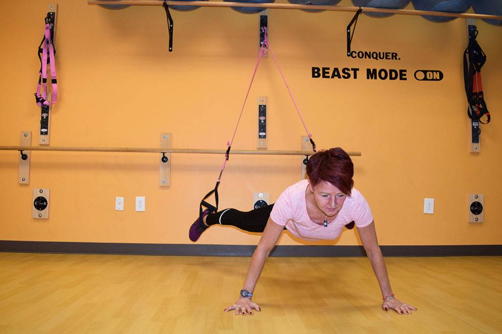 Pauline Geraci, owner and instructor at Fit4Life, demonstrates how to use the TRX equipment in her fitness studio. She plans to move the business space to a new space at 990 E. Washington St. set to by open by the beginning of January. Sequim Gazette photo by Erin Hawkins