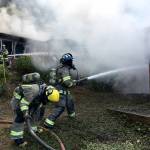 Clallam County firefighters attempt to combat flames on a Blyn house fire on Dec. 3. Sequim Gazette photo by Matthew Nash