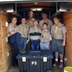 Boy Scouts with Troop 90 in Sequim stand inside the trailer that a thief or thieves broke into sometime last month and took about $900 in camping equipment. Troop leaders seek any support in replacing the items and in the mean time, scouts, from left, Aaron Wallen, 12, James Smith, 12, Connor Gosset, 17, Hunter Halverson, 13, Cayden Beauregard, 12, Beau Halverson, 15, and Shane Tenneson, 13, helped customers with carts and collecting blankets at Grocery Outlet on Dec. 8. Sequim Gazette photo by Matthew Nash