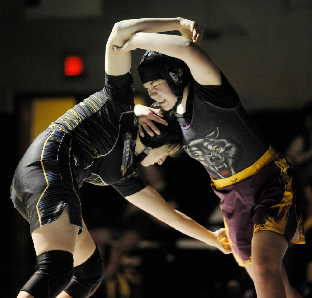 Jordan Hegtvedt of Sequim, right, wrestles North Masons Arynne Geier at 135 pounds in an Olympic League dual meet on Dec. 12. Sequim Gazette photo by Michael Dashiell