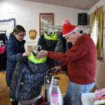 Amber Ahrens of Sequim looks over a coat with volunteer Jack Keith at Toys for Sequim Kids, which helped more than 350 children receive toys, games, clothes and more for Christmas. Sequim Gazette photo by Matthew Nash