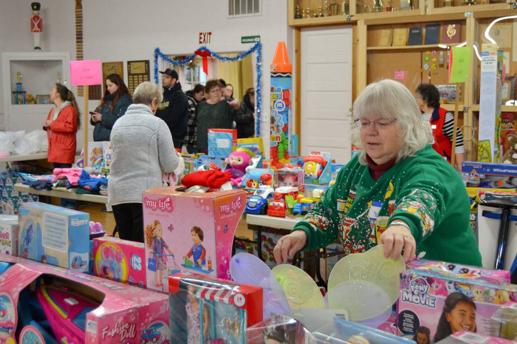 Donna Wade sorts butterfly wings while waiting to help Sequim residents pick out toys for their children on Dec. 12. Sequim Community Aid has continued Toys for Sequim Kids for 70-plus years. Sequim Gazette photo by Matthew Nash