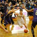 Sequim guard Nate Despain, center, looks for room to drive in a Dec. 18 Olympic League match-up against North Kitsap. Despite Despains 20 points, NK won the game 70-55. Sequim Gazette photo by Michael Dashiell