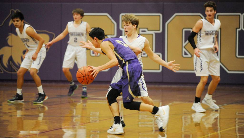 Sequim guard Kyler Rollness pressures North Kitsap guard Johny Olmsted in the first half of NKs 70-55 win in Sequim on Dec. 18. Rollness had 13 points in the loss. Sequim Gazette photo by Michael Dashiell