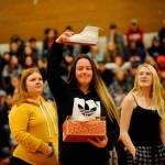Samantha White shows her new kicks to the crowd she received from one of Sonja Millers classes as a gift during the Winter Wishes assembly on Dec. 19. White said the shoes were fresh. Sequim Gazette photo by Matthew Nash