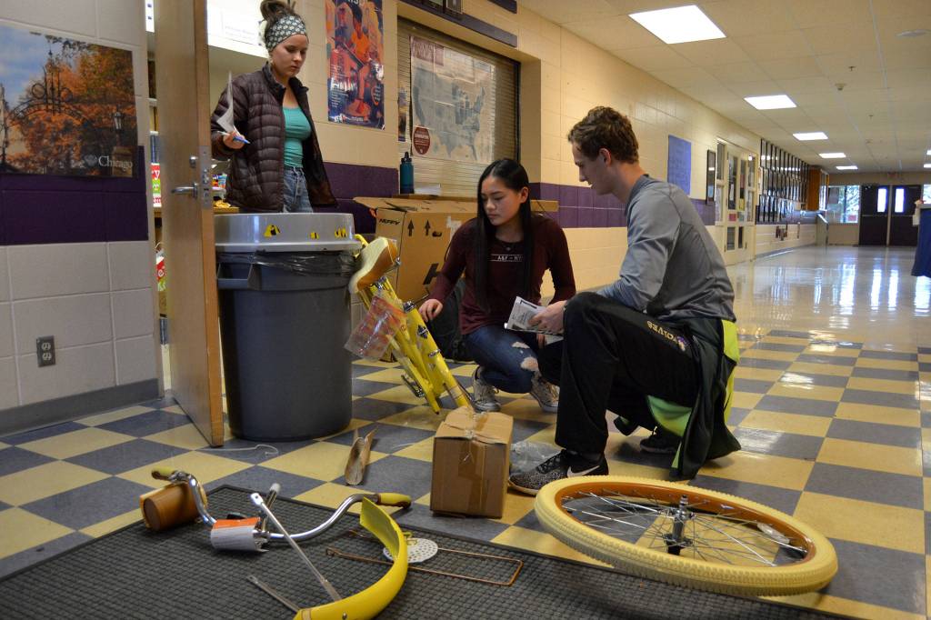 The night before the Winter Wishes assembly, Liam Payne, right, works with Alissa Lofstrom, left, and Shayli Schuman on building a bike for Gianna Halo. Fourteen people, including Halo, asked the Leadership class to help get her a bike.