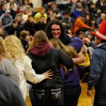Brandon Adams receives a big hug from fellow members of the Sequim FFA on Dec. 19. The club worked together to pay for an official FFA sweatshirt for him for the Winter Wishes assembly. Sequim Gazette photo by Matthew Nash