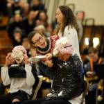 Students Maggie van Dyken, second from left, and Arlene Law put pies in Teacher Isaac Rapelje and Student Isabelle Hugoniots faces during the Winter Wishes assembly. In October, students won a contest for earning the most for breast cancer research and selected Rapelje to receive the pie. Hugoniot participated for fun. Sequim Gazette photo by Matthew Nash