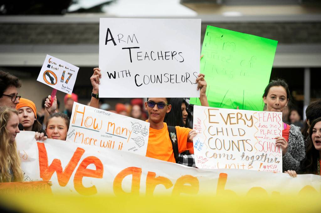 Trey Brouillard, center, and other Sequim High students express their views about gun control on the SHS campus on March 14. Sequim Gazette file photo by Michael Dashiell
