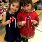 Mia Buhrer and Matilda Woodbury enjoy some holiday treats at Olympic Peninsula Academys annual Winter Fest on Dec. 14. Submitted photo