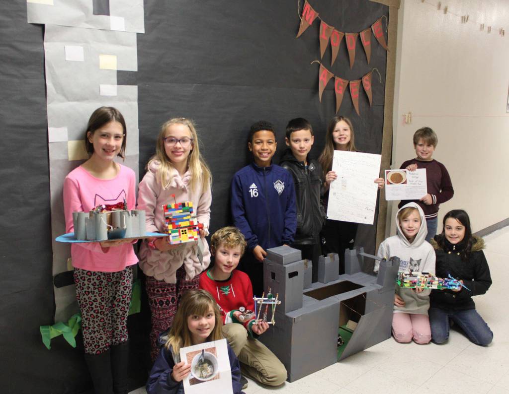 Students in Caryn Littles classes at Greywolf Elementary School show off their Middle Ages-inspired projects. They include (back row, from left): Kayhbree Henderson, with a cardboard/toilet paper rolls castle; Sariah Weller, with a LEGO castle; Myles Taylor, with a cardboard/duct tape castle; Elijah Chavez, with a LEGO castle; Lily Sparks, with an informational poster and flashcards, and Aidan Danielson, with a LEGO castle, with (front row, from left) Maisy French, with a cabbage pottage recipe; Stanley Baker, with a catapult; Kaitlyn Carpenter, with a LEGO castle (with help from classmate Areya Webb), and Lauren Cline, with a pottage recipe poster board. Photo by Darcy Lamb