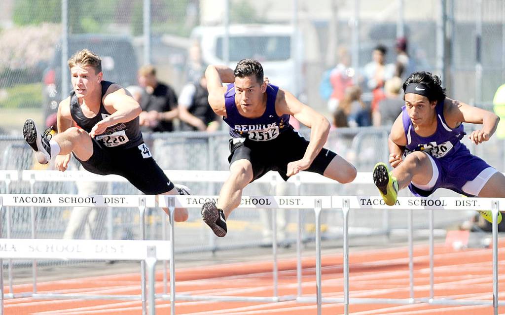 Sequims Riley Martin runs in the 110-meter hurdles at the 2A state Track and Field Championships at Mount Tahoma High School in May, finishing third in the state with a time of 15.30. Sequim Gazette file photo by Michael Dashiell