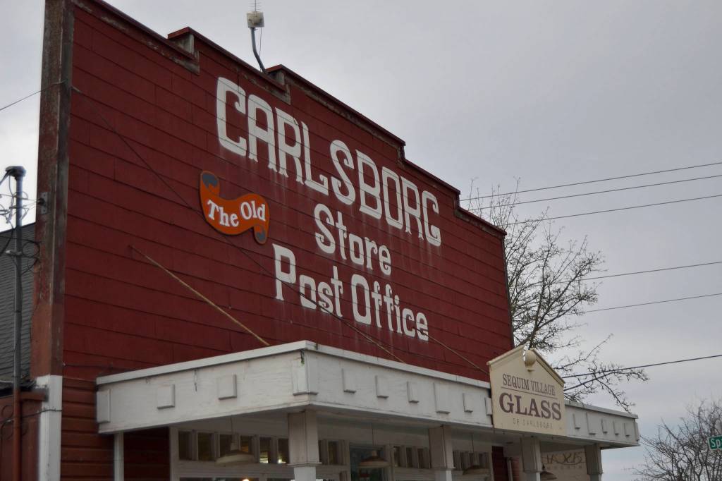 Above: Gil Simon, owner of Sequim Village Glass inside the old Carlsborg Store, said he says Carlsborg with a -Borg. Thats the correct name, I think, he said. Most people I speak to say -Borg. Its what youre used to hearing. Below: Christina Turner rings up a customer inside the Carlsborg Station that serves as a gas station, convenience store and Blimpies sandwich shop. She and other employees say theyve only heard Carlsborg pronounced as Carlsberg.