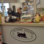 Christina Turner rings up a customer inside the Carlsborg Station that serves as a gas station, convenience store and Blimpies sandwich shop. She and other employees say theyve only heard Carlsborg pronounced as Carlsberg. Sequim Gazette photo by Matthew Nash