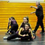 As coach Rich Hay provides instruction, Amara Sayer, bottom, and Alexi Rampp-Taft work on some moves in a late December practice. Sequim Gazette photo by Michael Dashiell