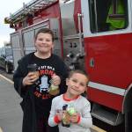 Helen Haller students Alex Kruckeberg, left, and Marcus Sheldon ready for rides home in a limo and a fire truck on Dec. 21 as a reward for earning the most for the schools Turkey Trot in November. Sequim Gazette photo by Matthew Nash