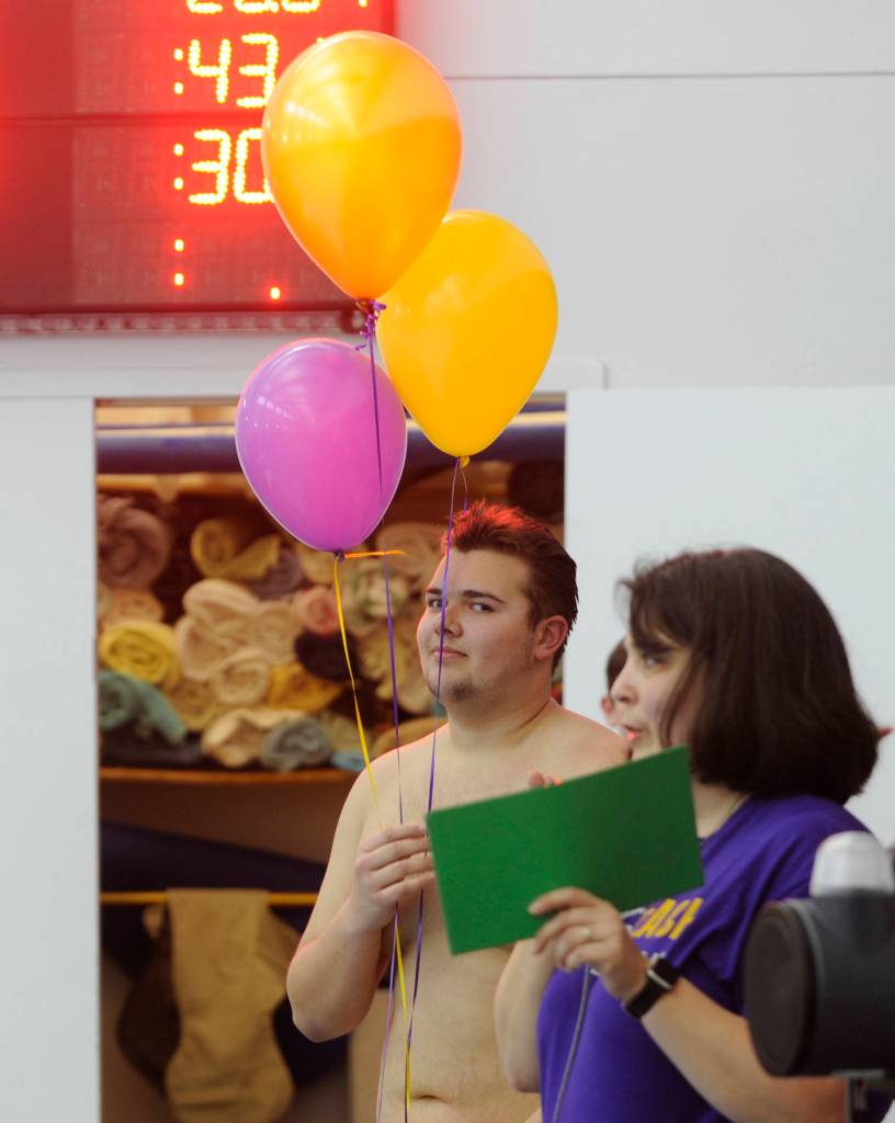 Anthony Porrazzo joins fellow seniors in receiving some accolades and gifts from coach Anita Benitez on Jan. 24, the Wolves final home meet of the 2018-2019 season. Sequim Gazette photo by Michael Dashiell