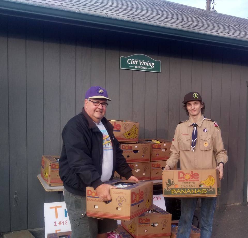 Devin Rynearson of Scout Troop 1498, pictured here with Sequim Food Bank board president Stephen Rosales, helps the troop finish an effort that brought the food bank $560 and 24 banana boxes filled with food in January. Rynearson organized the effort while completing his service hours for Life Scout. Submitted photo