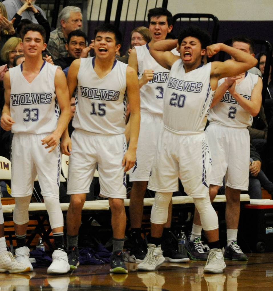 The Sequim bench erupts following Nate Despains three-point play to close the first half, one that gave the Wolves a 27-19 lead over rival Port Angeles. Pictured, from left, are Dallin Despain, Rigo Langston, Blake Wiker, Silas Lewis and Joey Oliver. Sequim Gazette photo by Michael Dashiell