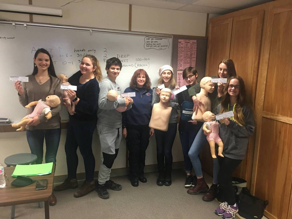 Olympic Peninsula Academy students (from left) Melanie Byrne, Cadence Puhrmann, Abram Yeater, (Sandy Boudrou of Fire District 3), Payton Johnson, Faith Amaya, Mia Coffman and Alyssa Alcaraz show off their certificates after completing CPR training. Submitted photo
