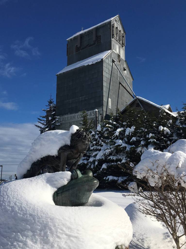 Snow covers the Sequim grain elevator on Sunday along with the statue Benjis Leap by Jay Wright. Sequim Gazette photo by Matthew Nash