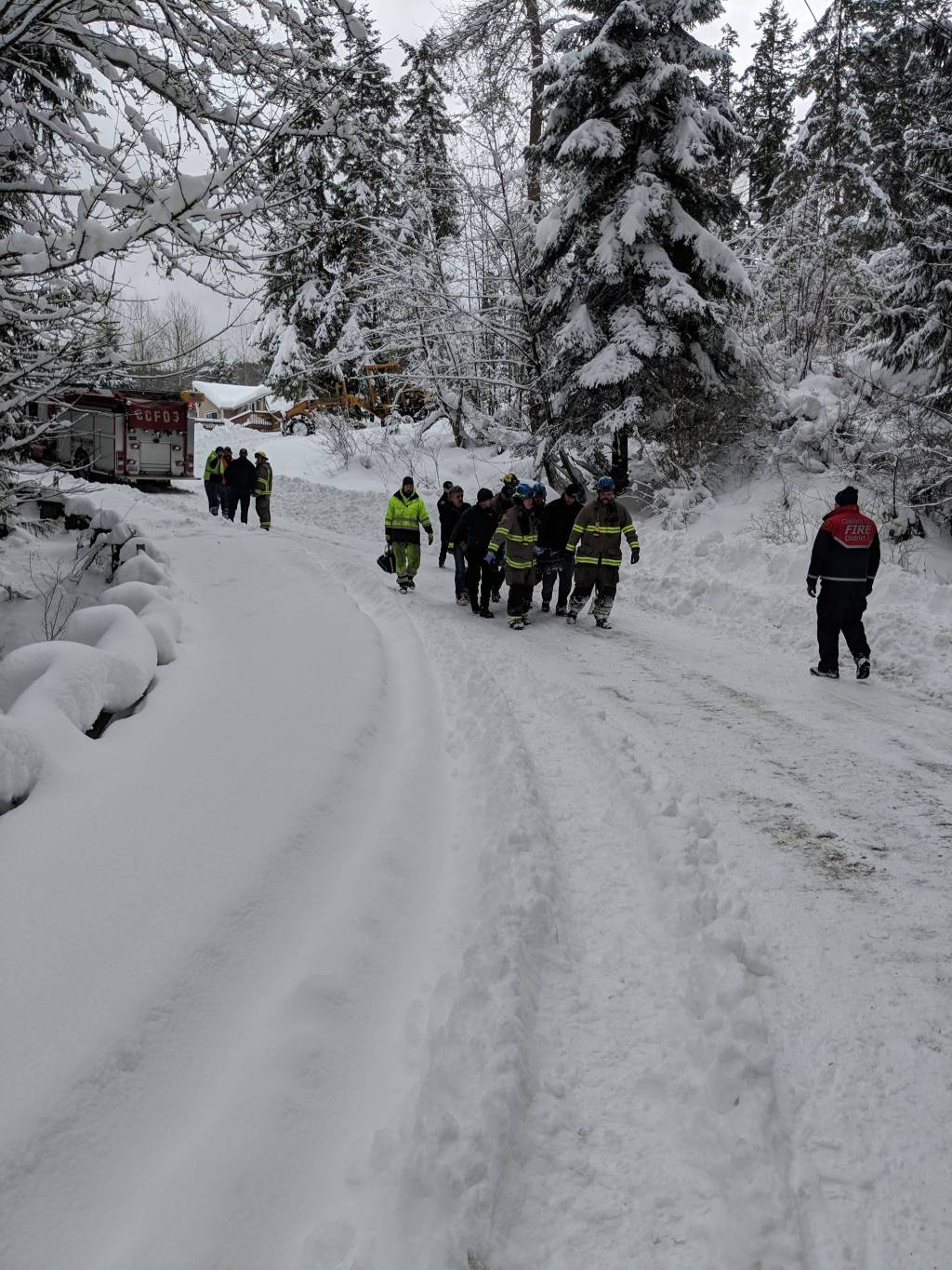 Due to snowy conditions, crewmen with Clallam County Fire District 3 carry an 85-year-old man to an SUV in order to airlift him to Seattle for care. Photo courtesy of Clallam County Fire District 3