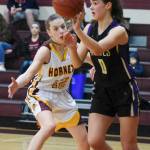 Sequims Hope Glasser looks for an open teammate while White Riverss Lee Audrey Norris applies pressure in a West Central District playoff game on Feb. 14. Photo by Kevin Hanson/The Courier Herald (Enumclaw)