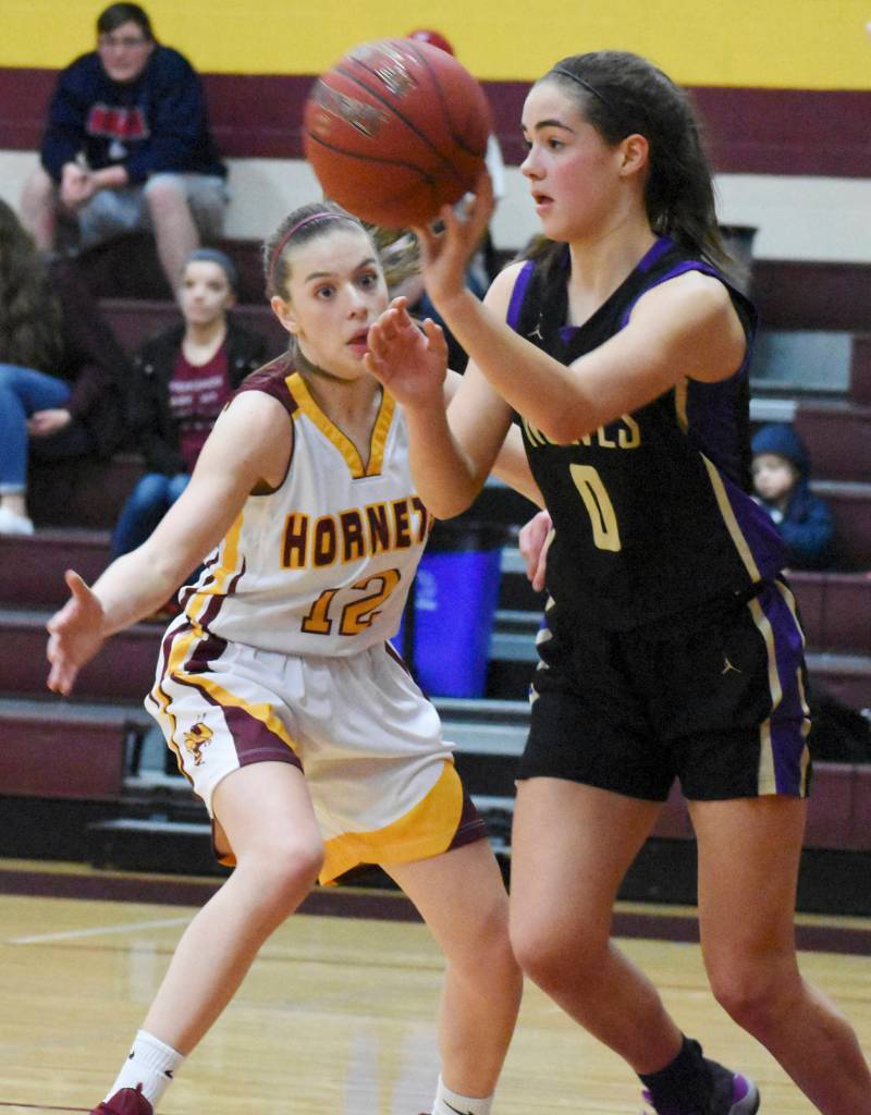 Sequims Hope Glasser looks for an open teammate while White Riverss Lee Audrey Norris applies pressure in a West Central District playoff game on Feb. 14. Photo by Kevin Hanson/The Courier Herald (Enumclaw)