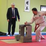 Joe Ryan breaks concrete tiles to display power during his black belt testing earlier this month. Ryan has been studying Taekwon-do for 18 years. Submitted photo