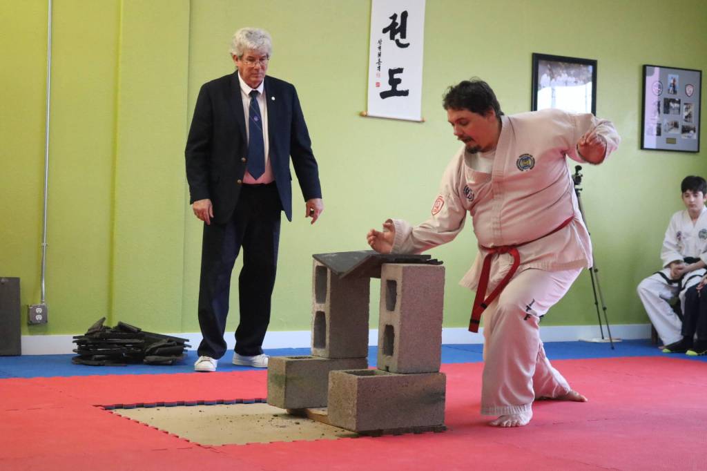 Joe Ryan breaks concrete tiles to display power during his black belt testing earlier this month. Ryan has been studying Taekwon-do for 18 years. Submitted photo