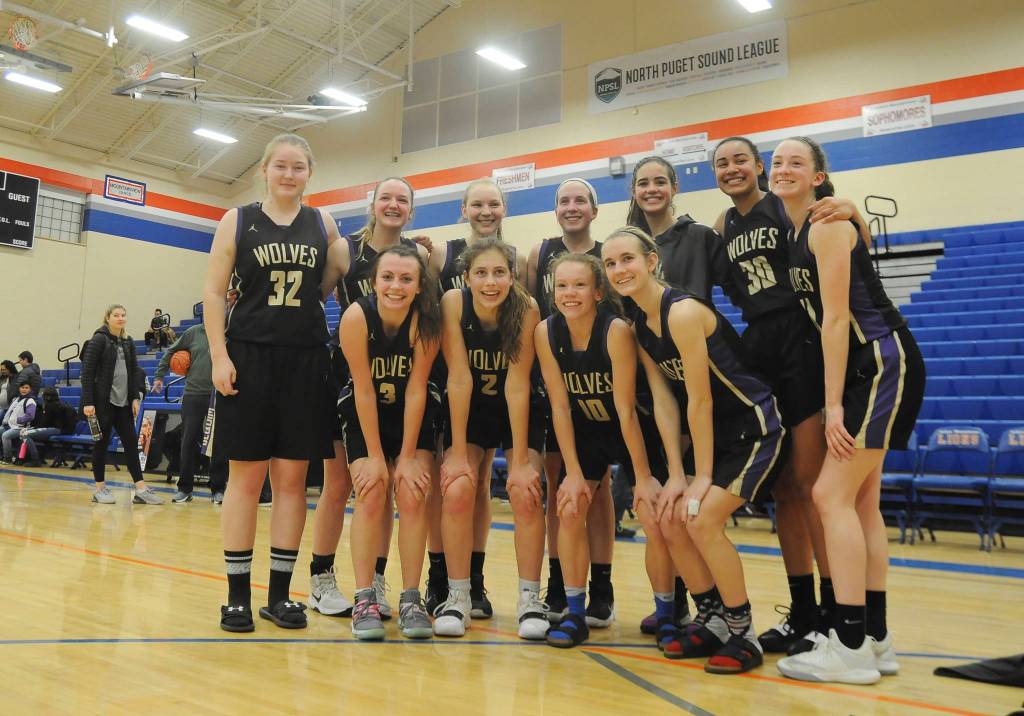 Sequims girls basketball squad celebrates a come-from-behind win over Foster in Auburn on Feb. 22, sending the Wolves to the state 2A tourney in Yakima this week. They include (back row, from left) LeeAnn Raney, Amanda Weller, Melissa Porter, Kalli Wiker, Hope Glasser, Jayla Julmist and Abby Schroeder, with (front row, from left) Bobbi Sparks, Jessica Dietzman, Riley Pyeatt and Hannah Wagner. Sequim Gazette photo by Michael Dashiell