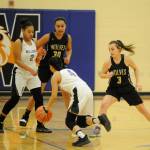 Sequims Bobbi Sparks, right, and Jayla Julmist defend Foster guard Meera Santos in the second half of the Wolves 54-44 win at regionals on Feb. 22. Sequim Gazette photo by Michael Dashiell