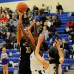 Sequim post Jayla Julmist, left, puts up a shot over Fosters Dyhani Frazier and Makanalani Montoya in the first half of Sequims win over the Bulldogs this past weekend, sending the Wolves to their fourth state tournament in school history. Julmist had nine points and 19 rebounds in the victory. Sequim Gazette photo by Michael Dashiell