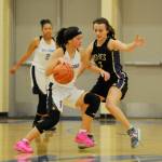 Sequims Bobbi Sparks, right, guards Fosters Makanalani Montoya in the waning moments of Sequims 54-44 win over Foster on Feb. 22, eliminating the Bulldogs from postseason play. Sequim Gazette photo by Michael Dashiell