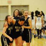 Sequims Bobbi Sparks, left, and Hannah Wagner help Jayla Julmist (30) off the court following a wild, 54-44 Sequim win in the regional round of the state 2A tournament against Foster on Feb. 22 in Auburn. Sequim Gazette photo by Michael Dashiell