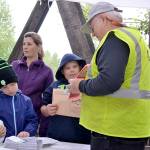 Elijah Wright left, Maddix Jay and Katie Magelssen listen in to a talk from Gordon Taylor from the Peninsula Trails Coalition on the Dungeness River Railroad Bridge at the 2015 Dungeness River Festival. Sequim Gazette file photo by Matthew Nash