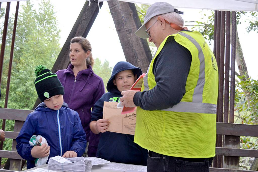Elijah Wright left, Maddix Jay and Katie Magelssen listen in to a talk from Gordon Taylor from the Peninsula Trails Coalition on the Dungeness River Railroad Bridge at the 2015 Dungeness River Festival. Sequim Gazette file photo by Matthew Nash