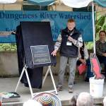 At the 2015 Dungeness River Festival, Clare Manis-Hatler and Ken Wiersema unveil a plaque certifying that the Dungeness River Railroad Bridge was placed on the National Register of Historic Places by the U.S. Department of the Interior. Its been registered since 1982 but Dungeness River Center supporters like Manis-Hatler wanted to make note of it for the bridges 100th anniversary. Sequim Gazette file photo by Matthew Nash