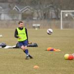 Mathys Tanche, an exchange student from Belgium, lofts a shot on goal at a preseason practice at the Albert Haller Playfields last week. Sequim Gazette photo by Michael Dashiell