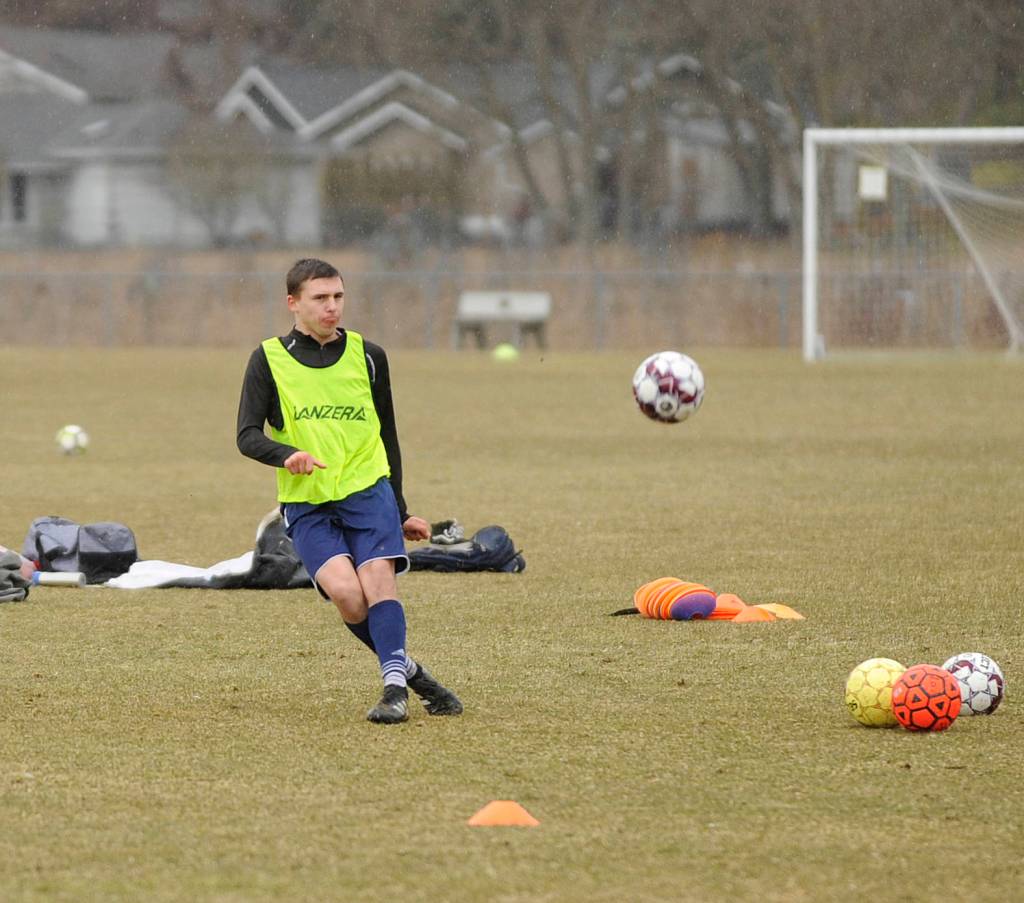 Mathys Tanche, an exchange student from Belgium, lofts a shot on goal at a preseason practice at the Albert Haller Playfields last week. Sequim Gazette photo by Michael Dashiell