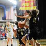 Port Angeles sophomore Madison Cooke, center, muscles her way to the basket as Sequims Hope Glasser (0) and Riley Pyeatt (10) defend the play. Cooke scored 18 points to lead PA past Sequim, 57-47, at the state 2A tourney on Feb. 27, ending the Wolves season. Sequim Gazette photo by Michael Dashiell