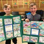 Second-graders Gus Mecham, left, and Trenton Kardonski show their displays about westward expansion in the United States during the 1800s. Submitted photo