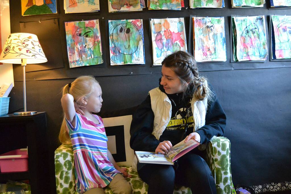 Above: Kindergartner Kenzie Seymour speaks with sophomore Natalya James during Read Across America in Stephanie Grotzke-Nashs class about her book. Right: Harrison Kuh, a third grader in Ann Riggs class, reads to Sequim High schooler Hunter Walters on March 1 for Read Across America Day.
