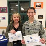 Two Civil Air Patrol members, senior member Sauni Holt and cadet CMSgt. Carson Holt, show certificates they received with challenge coins for their recent donation to the organizations unit in Sequim. Photo courtesy of Civil Air Patrol                                Two Civil Air Patrol members, senior member Sauni Holt and cadet CMSgt. Carson Holt, show certificates they received with challenge coins for their recent donation to the organizations unit in Sequim. Photo courtesy of Civil Air Patrol