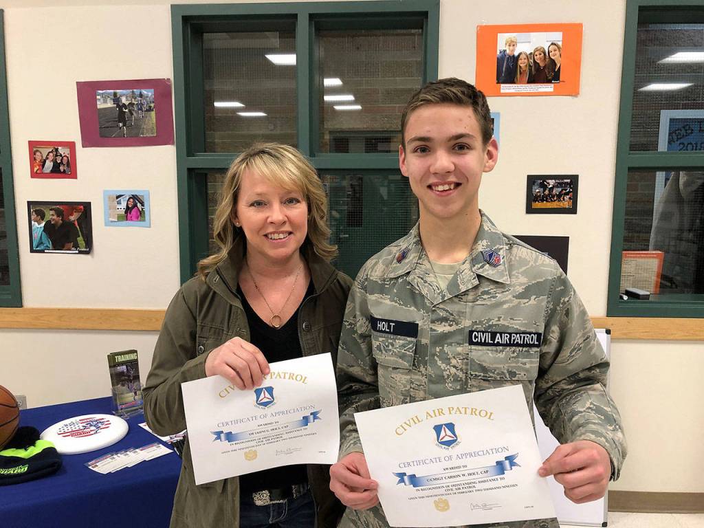 Two Civil Air Patrol members, senior member Sauni Holt and cadet CMSgt. Carson Holt, show certificates they received with challenge coins for their recent donation to the organizations unit in Sequim. Photo courtesy of Civil Air Patrol                                Two Civil Air Patrol members, senior member Sauni Holt and cadet CMSgt. Carson Holt, show certificates they received with challenge coins for their recent donation to the organizations unit in Sequim. Photo courtesy of Civil Air Patrol