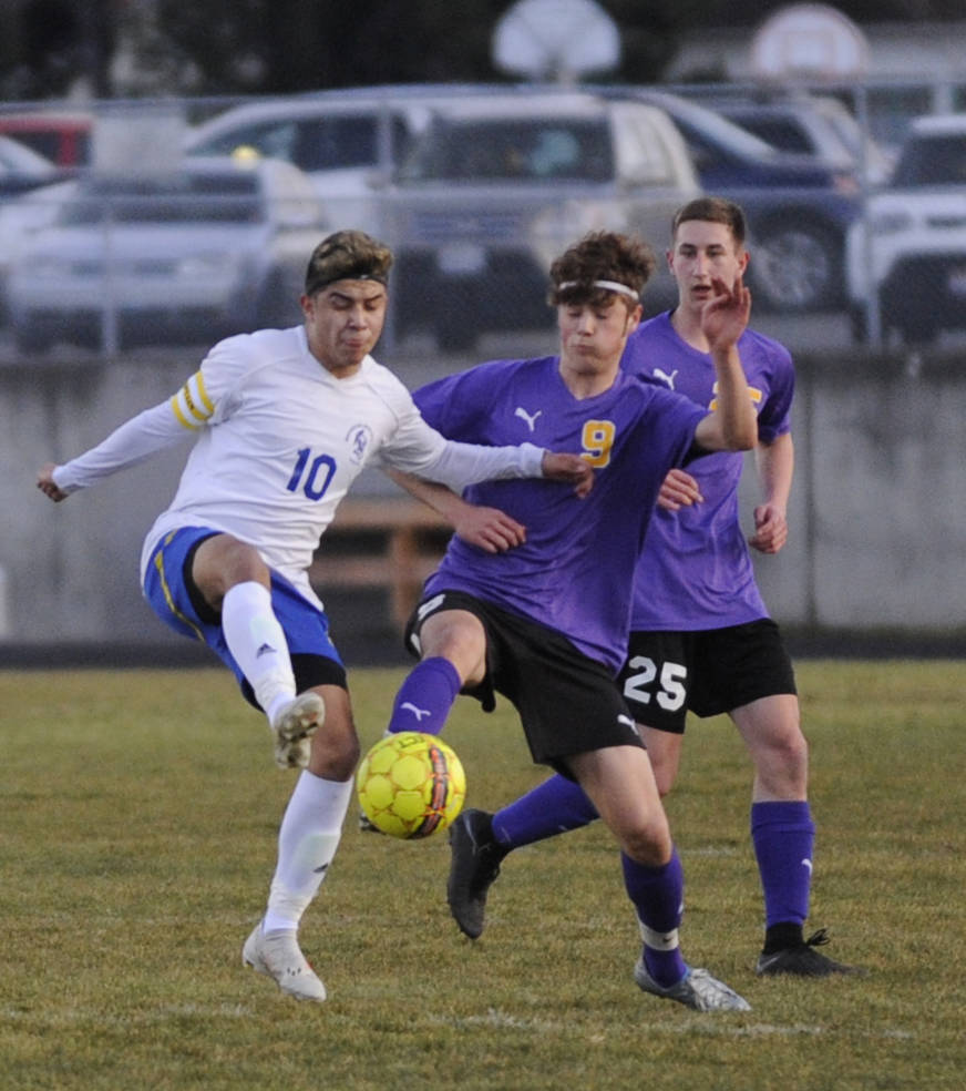 Sequims Adrian Funston, right, vies for possession with Bremertons Zachary Siltman. Sequim Gazette photo by Michael Dashiell