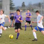 Sequims Sean Weber, center, dribbles through the Bremerton defense in the first half. Sequim Gazette photo by Michael Dashiell