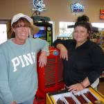 Hardys Market managers Shelly Cassalery, left, and Sendy Alvarez welcome customers at the stores antique tractor. Photo by Patricia Morrison Coate