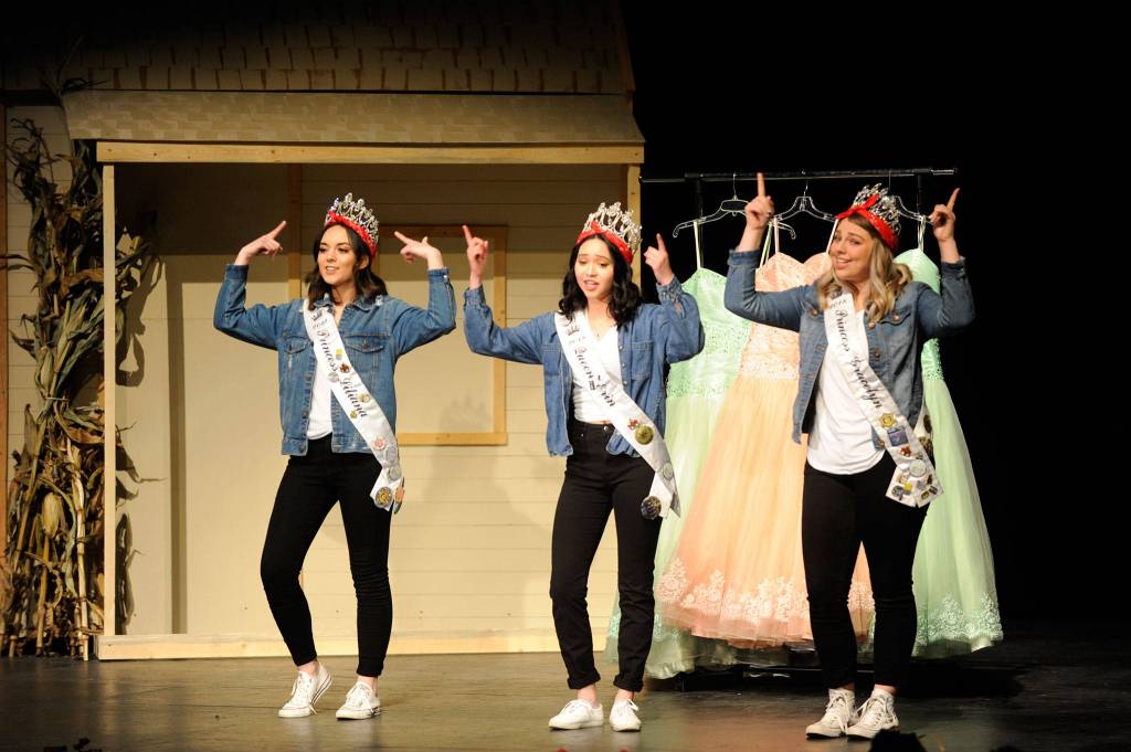 The 2018 royalty, from left, Princess Liliana Williams, Queen Erin Gordon and Princess Gracelyn Hurdlow dance and sing to their goodbye skit on March 14. They helped crown this years Sequim Irrigation Festival royalty court later in the show. Sequim Gazette photo by Matthew Nash